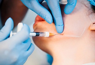 Woman receiving injection in her jaw