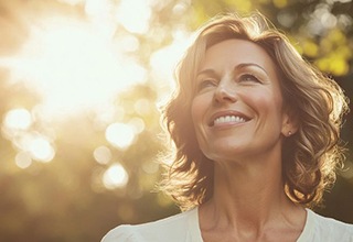 Smiling middle-aged woman standing outdoors