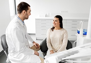 Dentist and patient talking in dental office